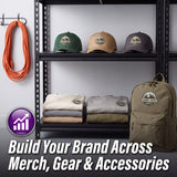 A promotional display showing branded outdoor apparel and accessories on a black shelving unit: three baseball caps on the top shelf, folded sweatshirts on the middle shelf, and a large backpack on the lower right. An orange coiled cord hangs on the left, and large text at the bottom reads 'Build Your Brand Across Merch, Gear & Accessories.