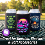 Three insulated can coolers displayed on aluminum cans outdoors on a metal picnic table. The coolers feature retro-style graphics: one neon green 'PLAYER ONE FUEL.
