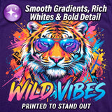 A purple graphic T-shirt design featuring a stylized tiger face wearing blue-purple sunglasses, surrounded by bright paint splashes and the words 'WILD VIBES' and 'PRINTED TO STAND OUT.' Large marketing text at the top reads 'Smooth Gradients, Rich Whites & Bold Detail.